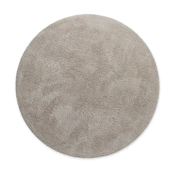 Runder Hochflor-Teppich aus weichem Material in Beige.