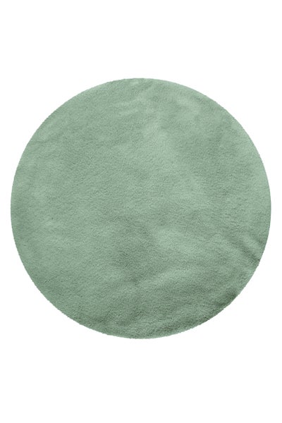 Runder Hochflor-Teppich in Salbeigrün mit einer weichen und flauschigen Oberfläche.