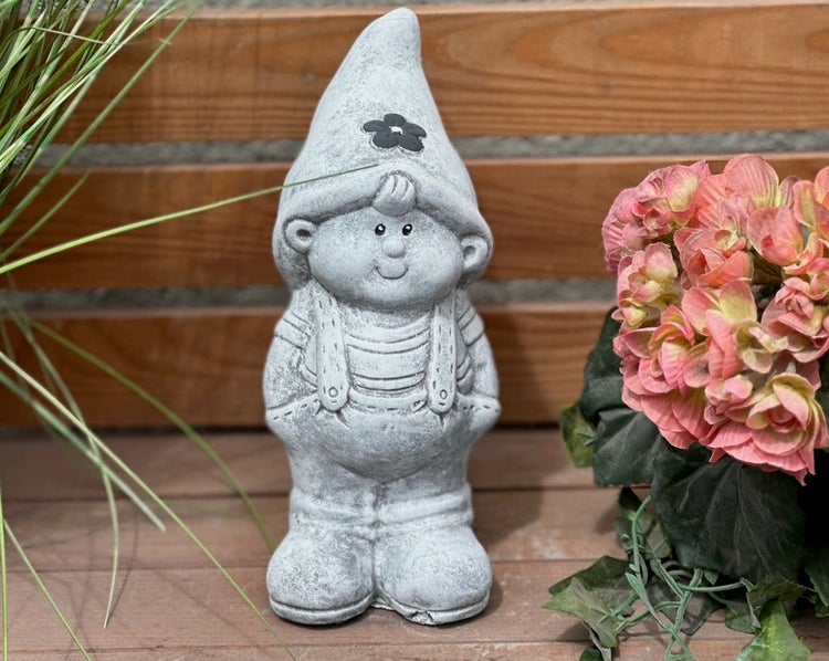 Graue Gartenzwerg-Figur aus Stein mit spitzem Hut und Blume, dekorative Gartenfigur.