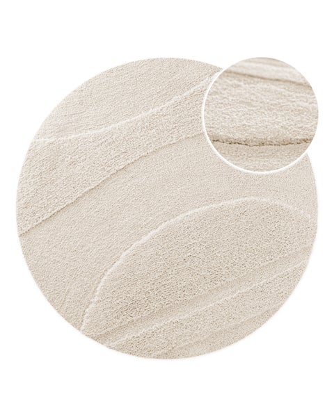 Runder Teppich in Beige mit Wellenmuster in Hoch-Tief-Optik und Detailansicht der weichen Textur.