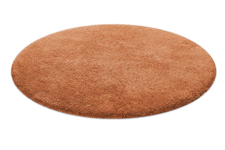 Runder Hochflor-Teppich in Terrakotta mit weicher Shaggy-Oberfläche.