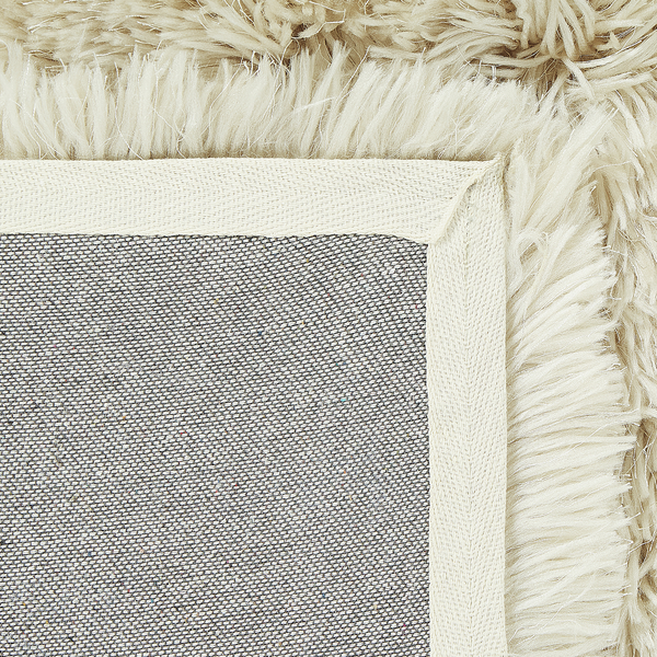 Detailansicht eines Teppichs mit Fransen und Textilrücken