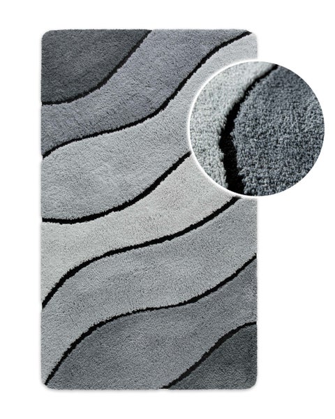 Badematte mit Wellen-Design in Grautönen, flauschige Textur mit Detailansicht.