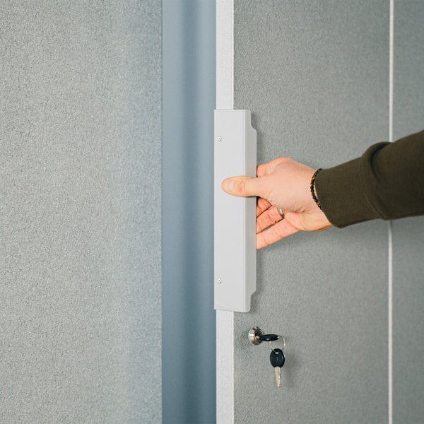 Hand öffnet Stahlschrank mit Schlüssel