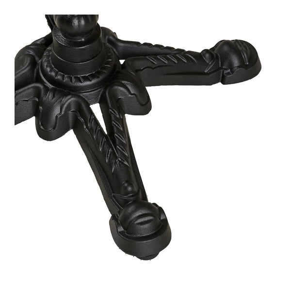 Detailaufnahme eines schwarzen Tischfußes aus Metall mit Verzierungen