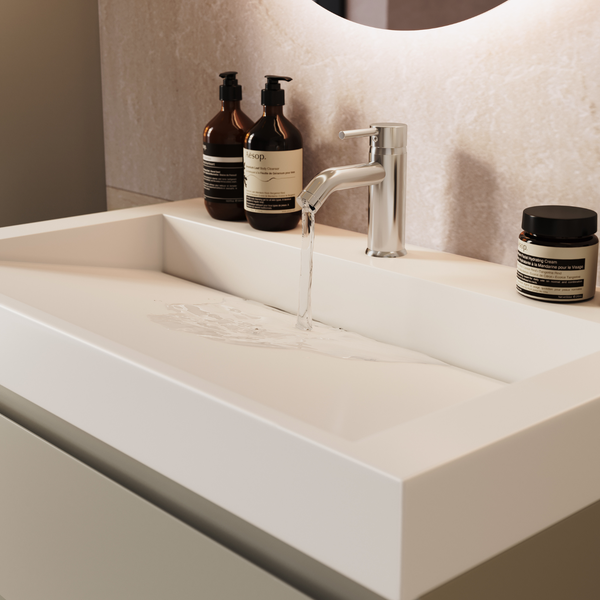 Modernes Waschbecken mit Armatur und fließendem Wasser in einem Badezimmer.