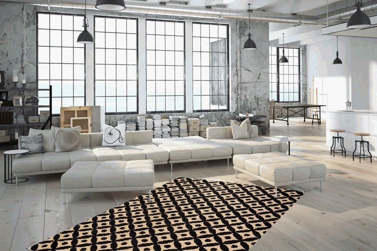 Großes, helles Wohnzimmer im Industriestil mit modularem Sofa, passenden Hockern und geometrisch gemustertem Teppich auf Holzboden.