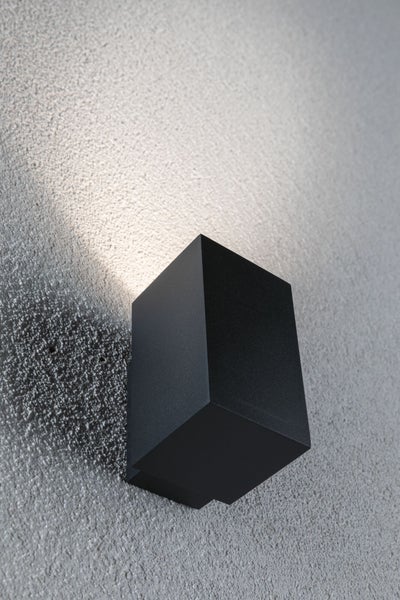 Moderne quaderförmige Wandleuchte für den Außenbereich mit Lichtkegel an der Wand