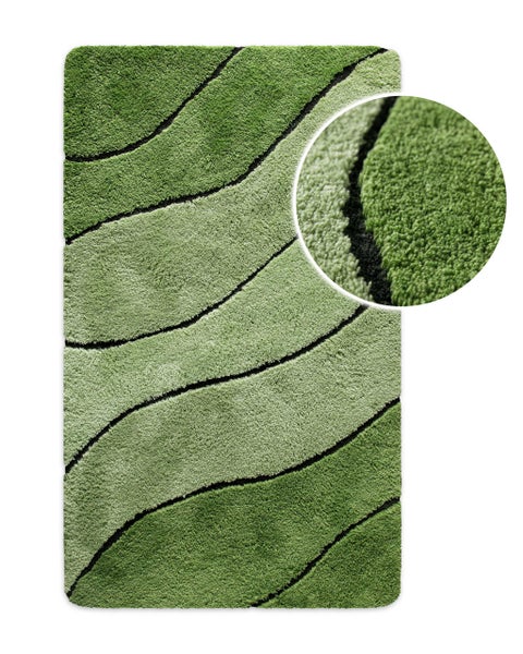 Grüner Badteppich mit Wellenmuster und Hochflor.