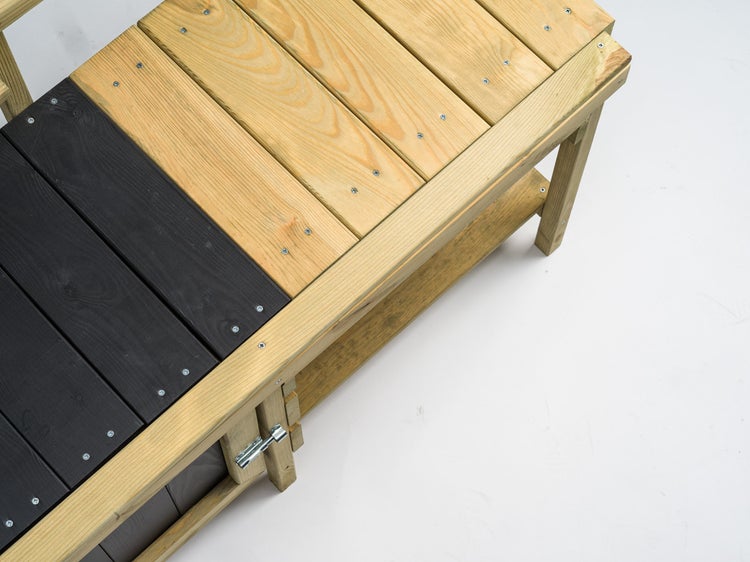 Detailansicht eines Hochbeets aus Holz mit teilweise dunklen Elementen.