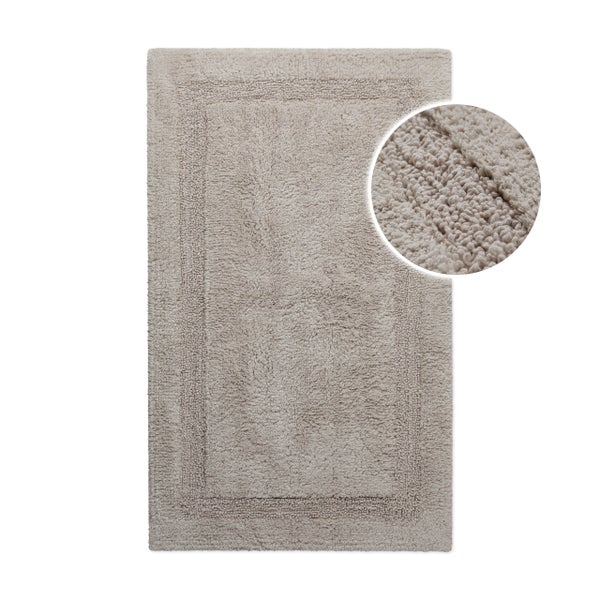 Rechteckige beige Badematte mit Schlingenstruktur und Rahmenbordüre.