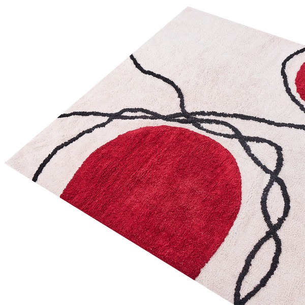 Hochflor-Teppich mit abstraktem Muster aus einem roten Kreis und schwarzen Wellenlinien.
