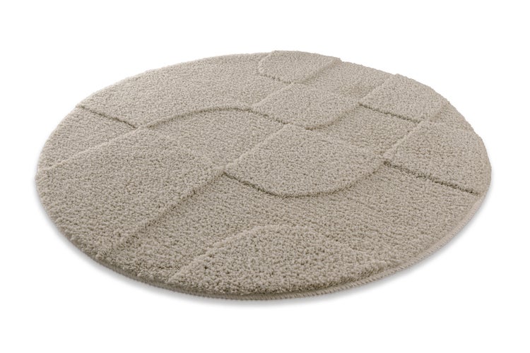 Runder Hochflor-Teppich mit Reliefmuster aus Wellenlinien in Beige.