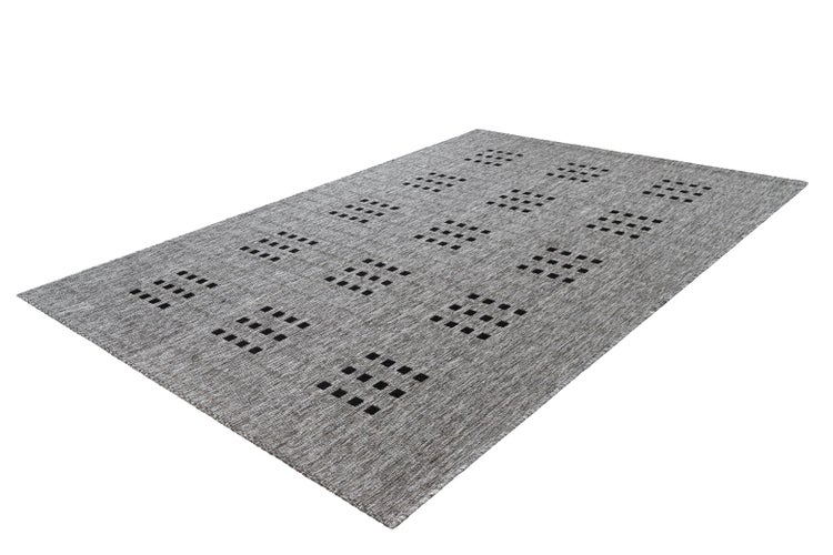 Flachgewebe-Teppich mit geometrischem Muster aus kleinen schwarzen Quadraten auf grauem strukturiertem Grund.