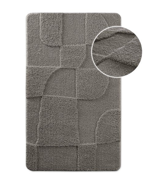 Rechteckige Badematte mit geometrischem Reliefmuster und Detailansicht der weichen Textur.