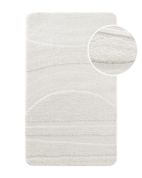 Badematte mit strukturiertem Wellenmuster, weichem Flor und abgerundeten Ecken, inklusive Detailansicht der Oberflächenstruktur.