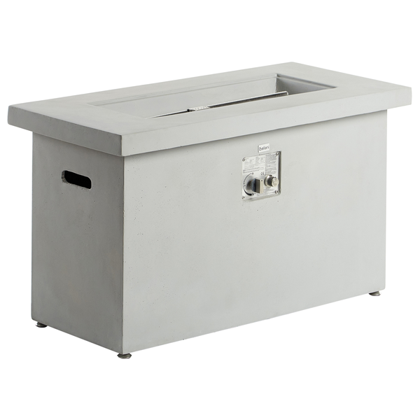 Moderner Außenbereich mit rechteckiger Gas-Feuerstelle auf einer gepflasterten Terrasse, Außenküche und Waldhintergrund.