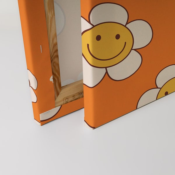 Nahaufnahme einer Leinwand mit lächelnden Gänseblümchen auf orangefarbenem Hintergrund
