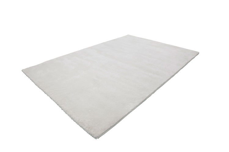 Rechteckiger weißer Hochflor-Teppich mit weicher Textur.