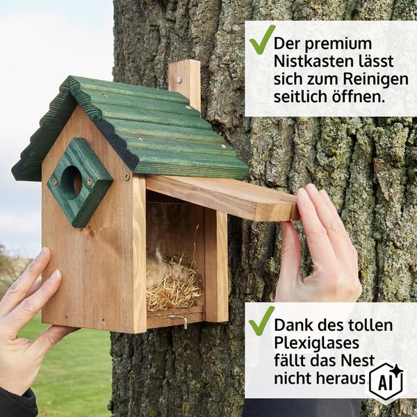 Hölzerner Nistkasten mit aufklappbarer Seitenwand zur Reinigung und Plexiglasscheibe an einem Baum hängend