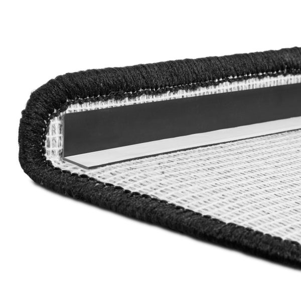 Detailansicht einer Treppenstufe mit Teppich und Winkelprofil