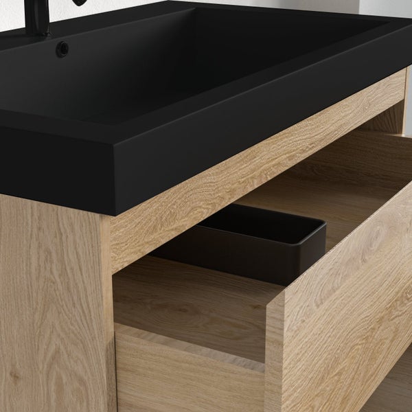 Waschbeckenunterschrank in Holzoptik mit schwarzem Waschbecken und einer geöffneten Schublade inklusive Organizer.