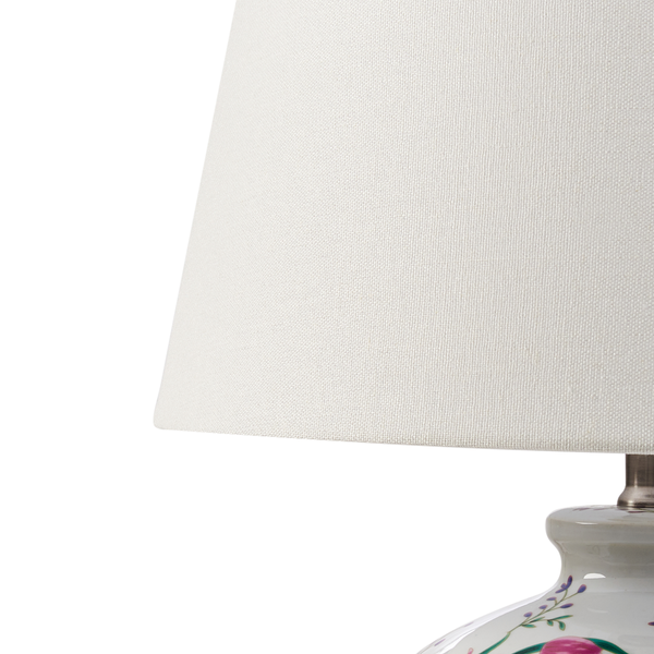 Detail einer Lampe mit Stoffschirm und floralem Porzellansockel