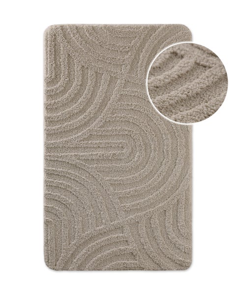 Beige rechteckige Badematte mit wellenförmigem Strukturmuster und Detailansicht der weichen Oberfläche.