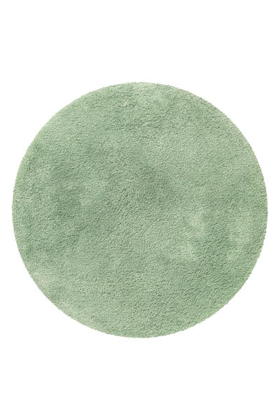 Runder Hochflor-Teppich in Grün, weiche Shaggy-Struktur.