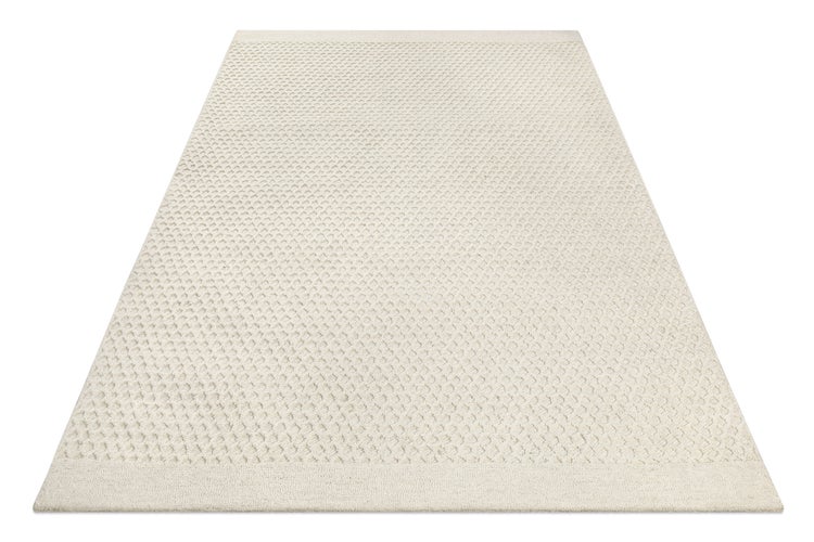 Strukturierter rechteckiger Teppich in Hellbeige mit Wabenmuster und gewebten Bordüren.