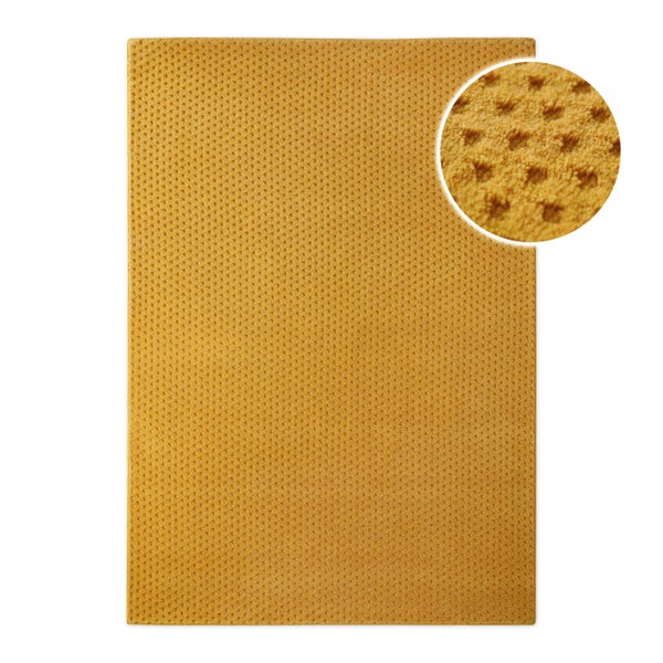 Gelber rechteckiger Teppich mit Waffelstruktur und Detailansicht der weichen Oberfläche.