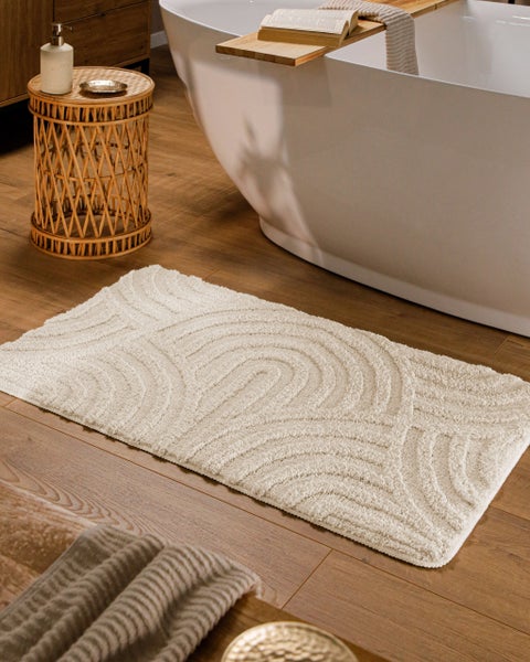 Symbol für 100 Prozent Polyester Material mit einem grünen Frosch mit Krone auf einem Teppich.