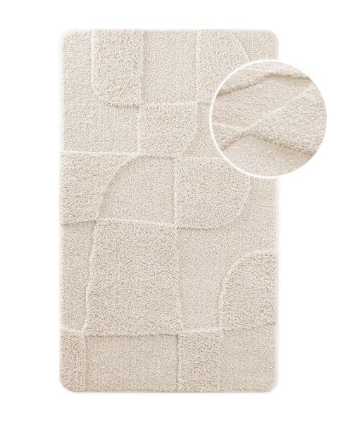 Hellbeige Badematte mit geometrischem Hoch-Tief-Muster aus weichem Hochflor, Detailansicht der strukturierten Oberfläche.