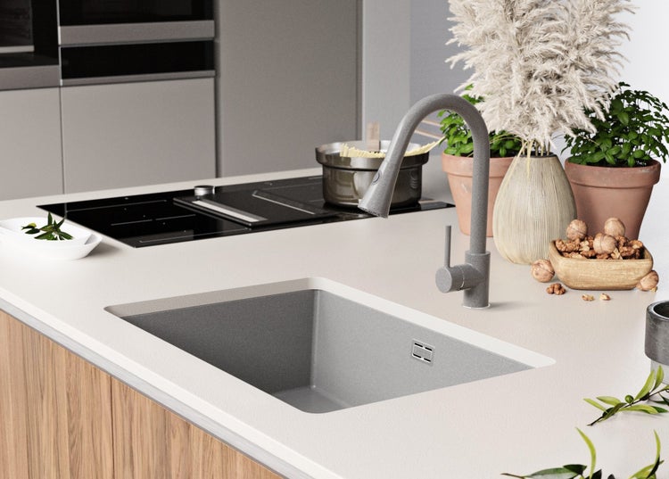 Küchenszene mit Spüle, Armatur, Kochfeld und Dekoration auf der Arbeitsplatte