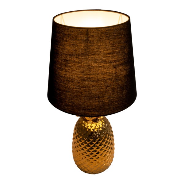 Tischleuchte mit einem Schirm und einem Ananas-förmigen Sockel