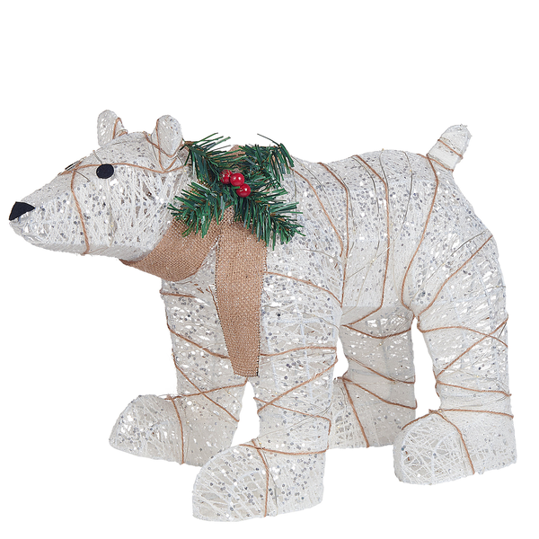 Dekorativer Eisbär mit Schleife und Tannenzweigen als Weihnachtsdekoration