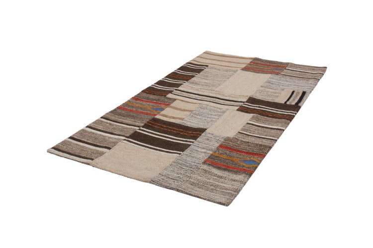 Rechteckiger Patchwork-Teppich mit Streifenmustern und geometrischen Details.