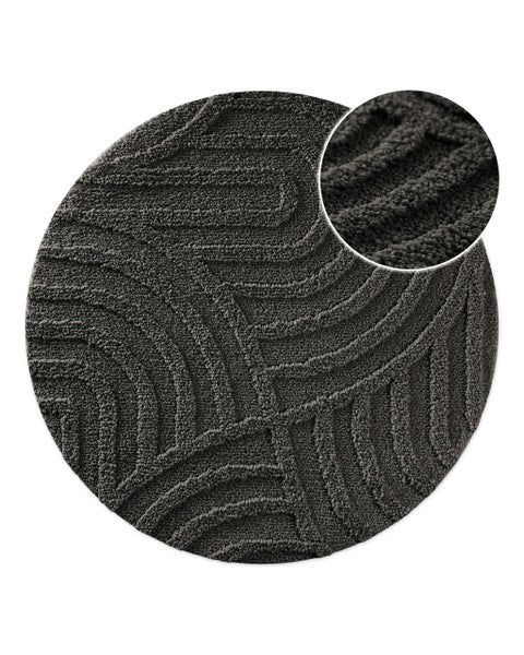 Runder Badeteppich in Dunkelgrau mit Wellenmuster und Detailansicht der weichen Faserstruktur.
