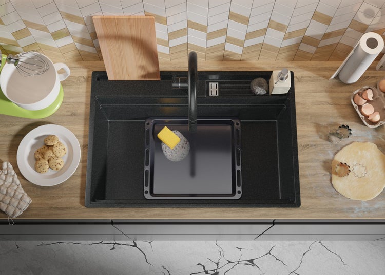 Spüle mit Spülmittel, Schwamm, Backblech, Teig und Ausstechformen auf einer Küchentheke