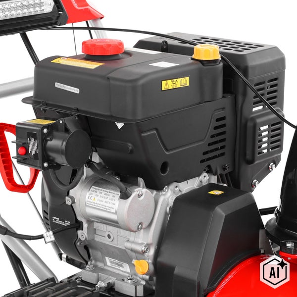 Detailansicht des Benzinmotors einer Schneefräse mit Starterknopf und Tankverschlüssen