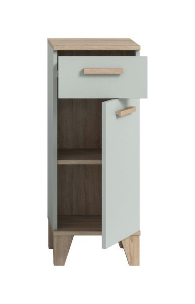 Ein schmaler Badezimmerschrank mit einer Schublade und einer Tür, die ein offenes Fach freigibt, auf vier Holzfüßen stehend.