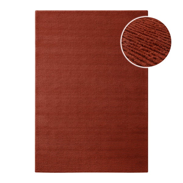 Rechteckiger Teppich mit gerippter Struktur und Detailansicht der Textur.
