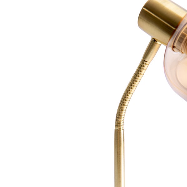Detailansicht einer goldenen Schreibtischlampe mit flexiblem Arm