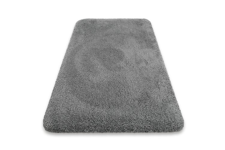Grauer Hochflor-Teppich, rechteckig mit abgerundeten Ecken, weiche Textur.