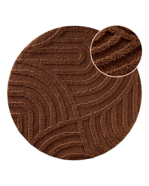 Runde Badematte in Braun mit strukturiertem Wellenmuster aus weichem Hochflor.