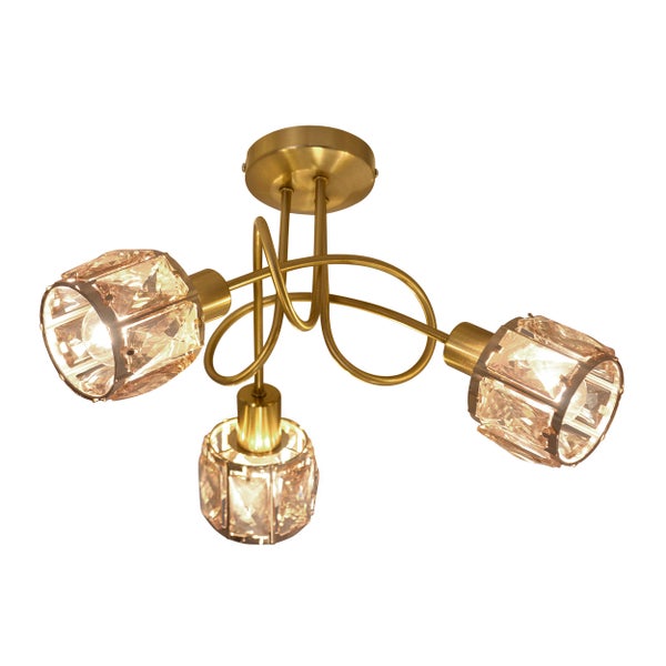 Innenaufnahme eines Wohnzimmers mit einer goldenen Deckenleuchte mit drei Lampen über einem weißen Sofa.