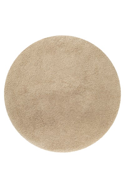 Runder Hochflor-Teppich in beige.