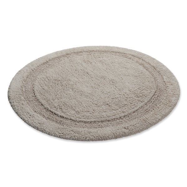 Runder Badeteppich beige mit strukturierter Oberfläche und dekorativem Rand.