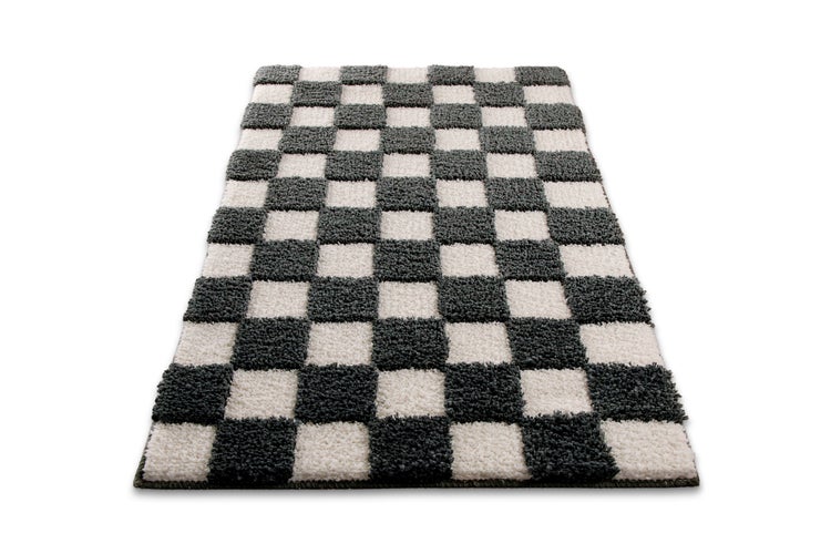 Rechteckiger Hochflor-Teppich mit grau-weißem Karomuster.