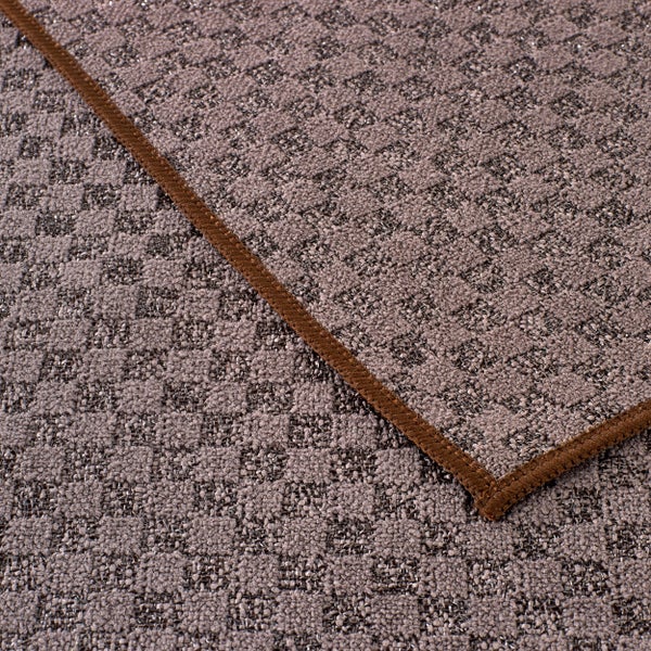 Detailansicht eines gemusterten Teppichs mit Bordüre